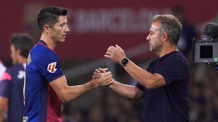 Robert Lewandowski and Barcelona boss Hansi Flick shake hands after a game